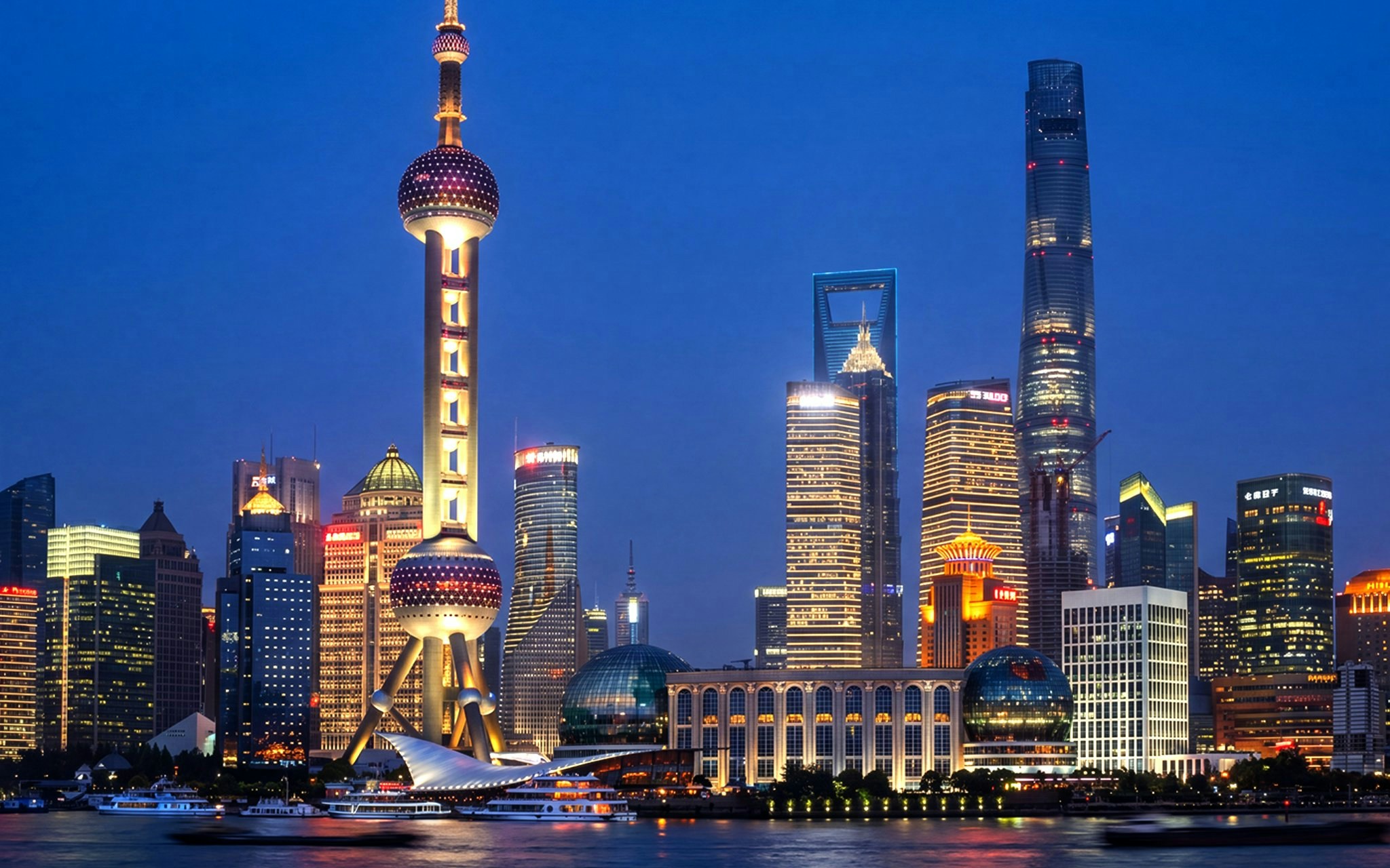 Oriental Pearl Tower illuminated at night in Pudong, Shanghai, viewed from across the Huangpu River.