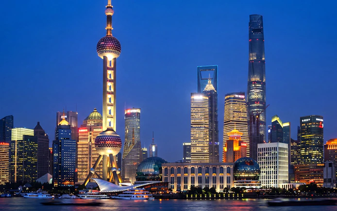 Oriental Pearl Tower illuminated at night in Pudong, Shanghai, viewed from across the Huangpu River.