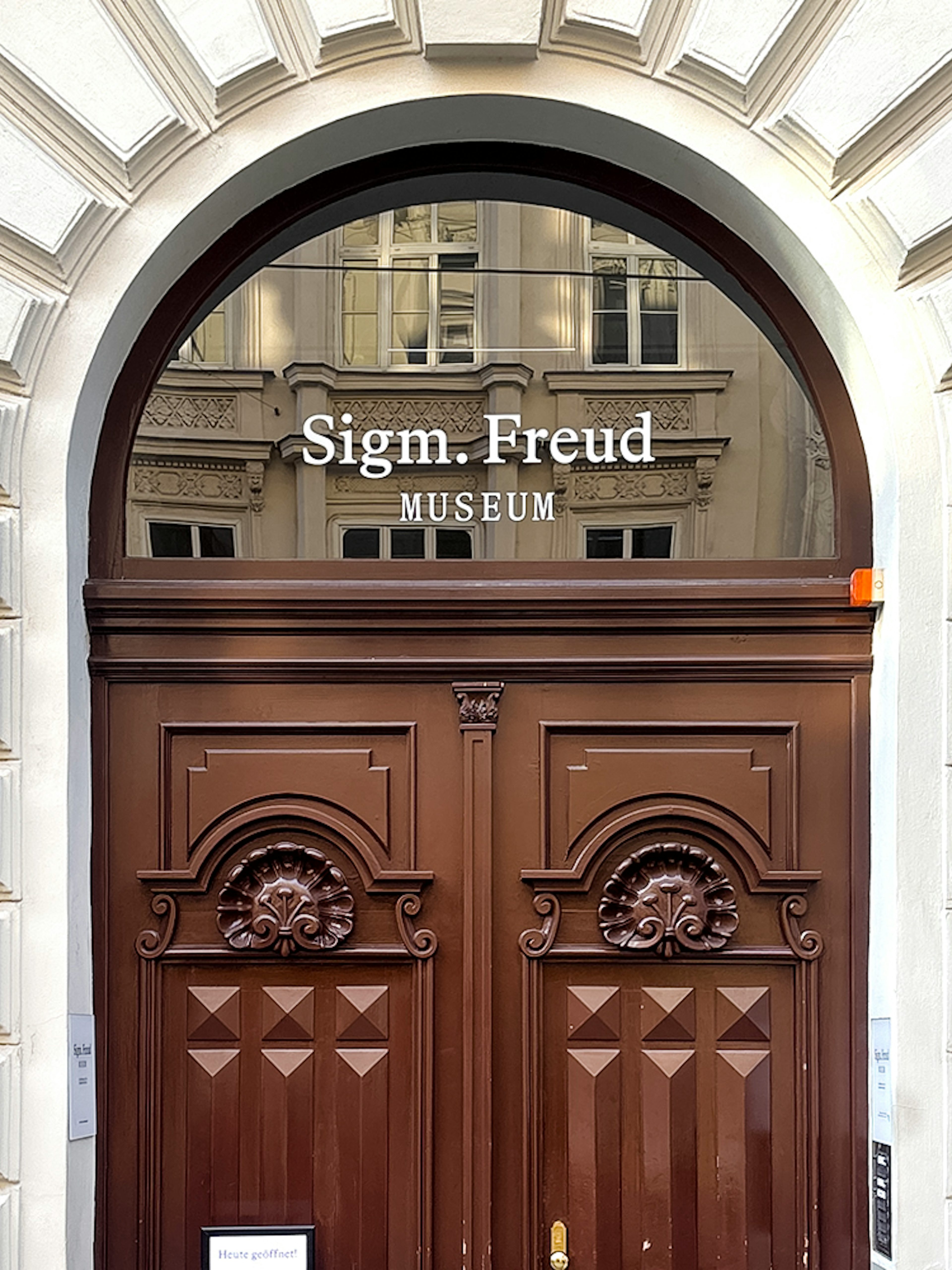 Sigmund Freud Museum entrance with wooden doors in Vienna.