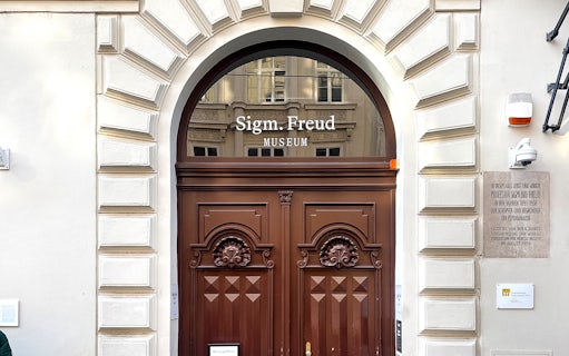 Sigmund Freud Museum entrance with wooden doors in Vienna.