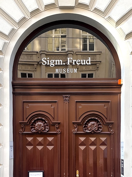 Sigmund Freud Museum entrance with wooden doors in Vienna.