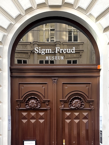 Sigmund Freud Museum entrance with wooden doors in Vienna.