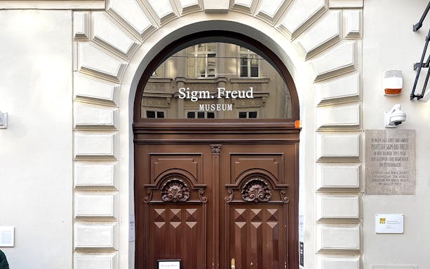 Sigmund Freud Museum entrance with wooden doors in Vienna.