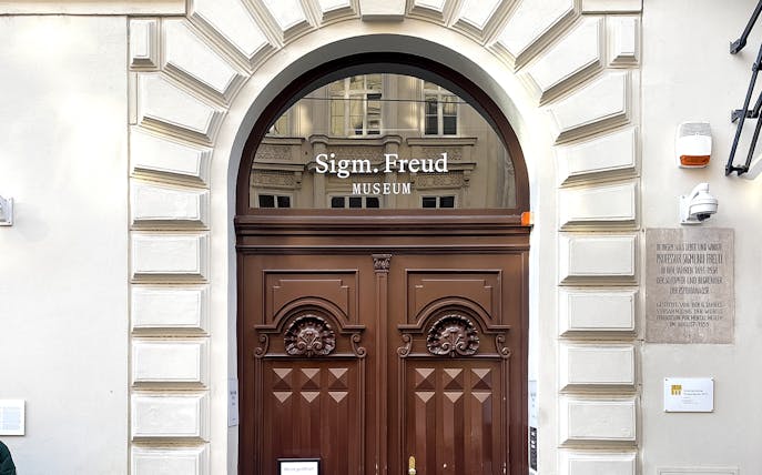 Sigmund Freud Museum entrance with wooden doors in Vienna.