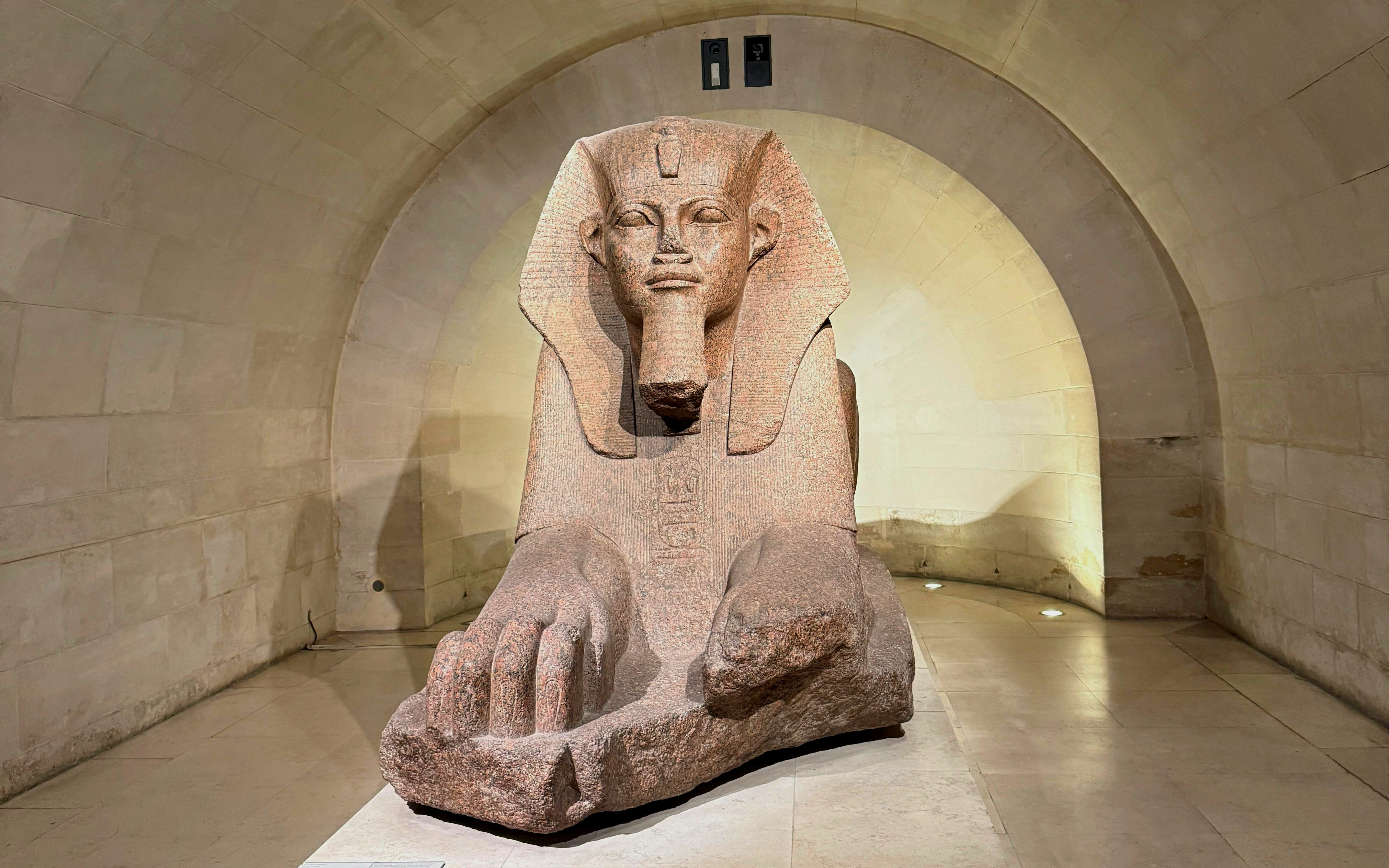 Sphinx statue in the Egyptian Antiquities section of the Louvre, Paris.