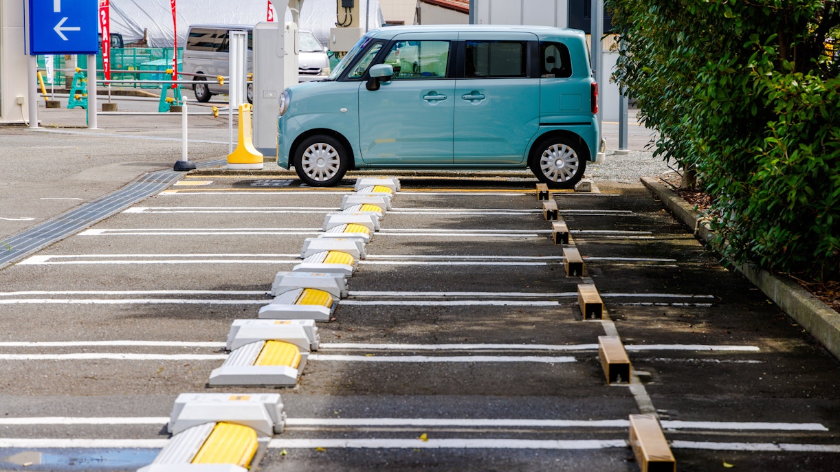 Car parked in a designated hourly parking space in Japan.