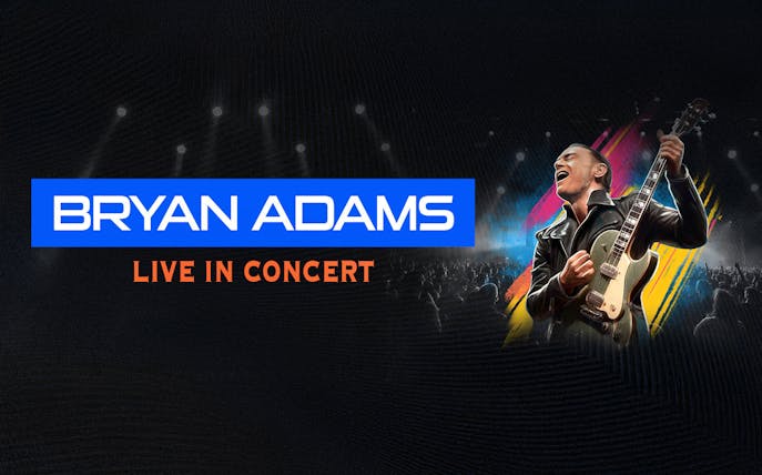 Bryan Adams performing live with guitar at Etihad Arena concert.