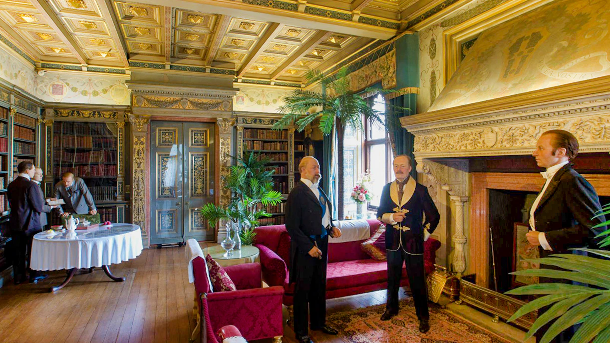 Warwick Castle interior with wax figures in period attire, showcasing historical decor.