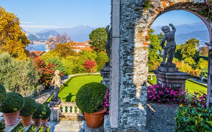 Statues and gardens at Isola Bella with Lake Maggiore in the background.
