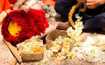 Lei making with yellow flowers at Na Lei Aloha Luau, Waikīkī.