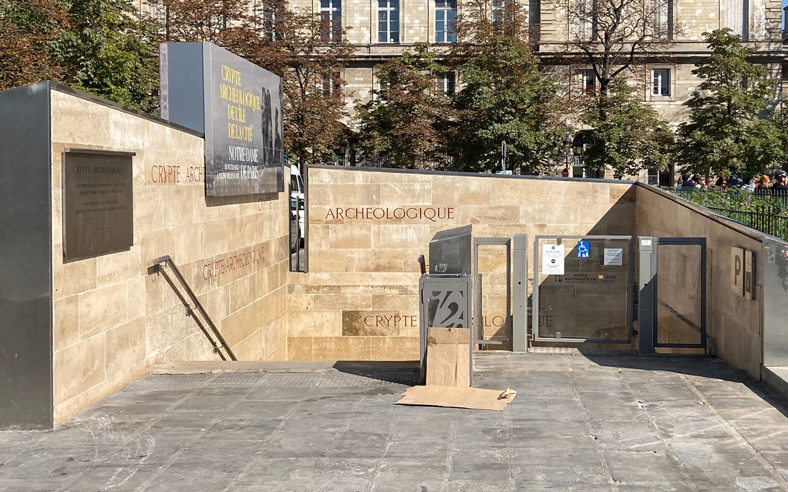 Notre Dame Archaeological Crypt entrance in Paris with informational signage.