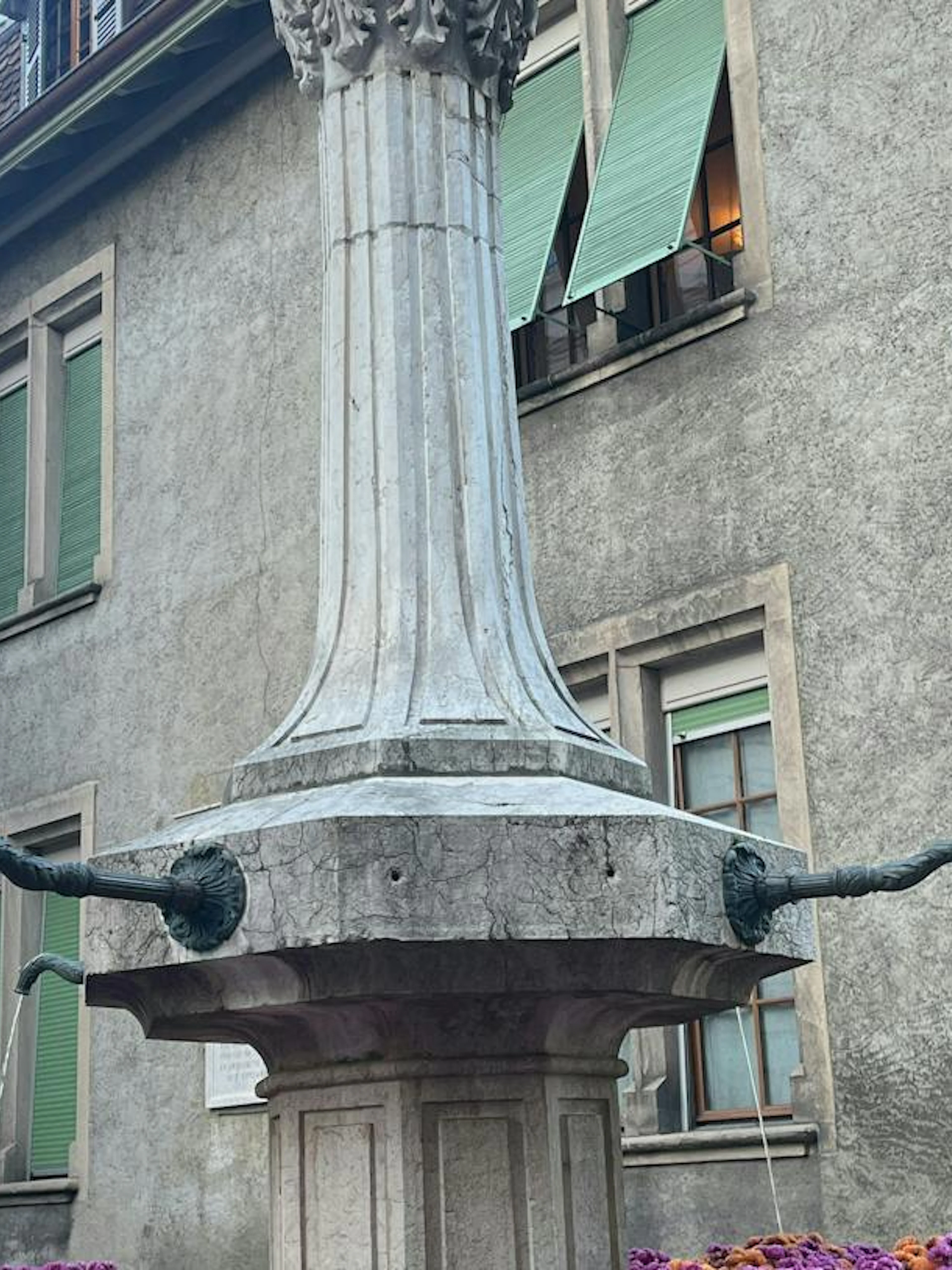 Historic fountain on Rue Jean-Calvin in Geneva, part of the self-guided city exploration game.