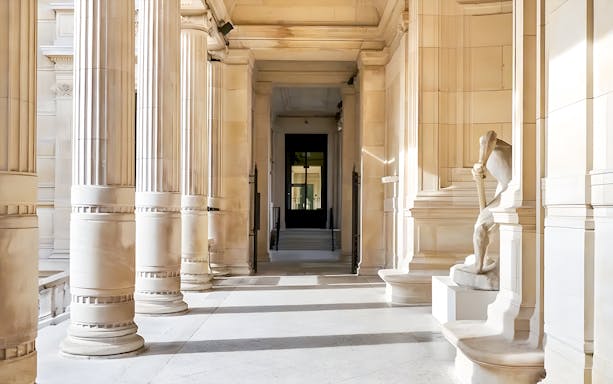Palais Galliera corridors with elegant arches and historic architecture in Paris, France.