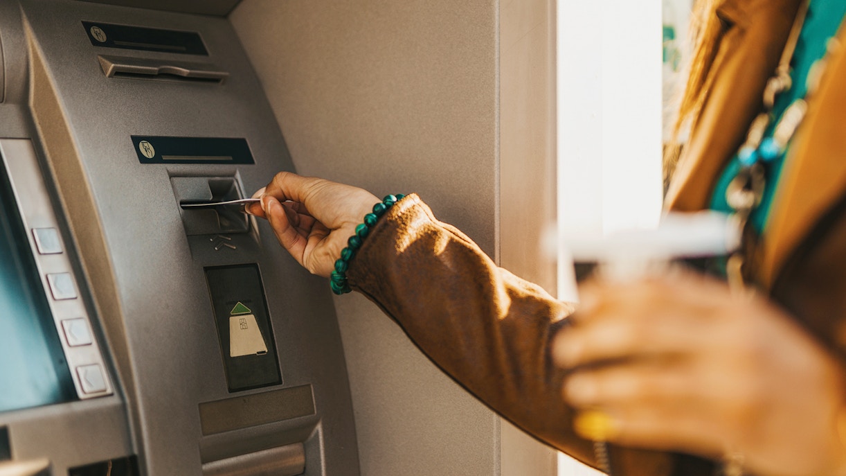 Inserting card into ATM machine.