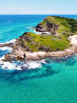 Aerial view of rocky coastline and turquoise waters on Fraser Island, Australia.