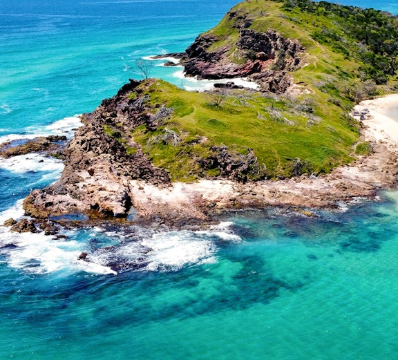 Aerial view of rocky coastline and turquoise waters on Fraser Island, Australia.