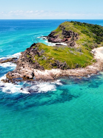 Aerial view of rocky coastline and turquoise waters on Fraser Island, Australia.