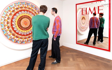 Visitors viewing contemporary art at Moco Museum, Amsterdam, featuring Banksy pieces.