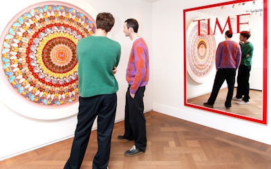 Visitors viewing contemporary art at Moco Museum, Amsterdam, featuring Banksy pieces.