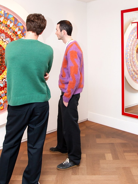 Visitors viewing contemporary art at Moco Museum, Amsterdam, featuring Banksy pieces.