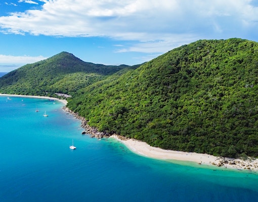 Aerial view of Fitzroy Island's lush green hills and turquoise waters, Australia.