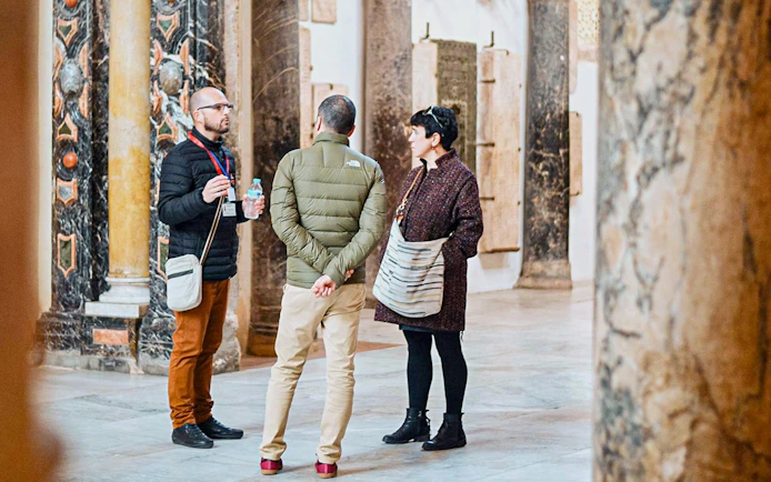 Tourists listening to a guide inside Cordoba Mosque-Cathedral.
