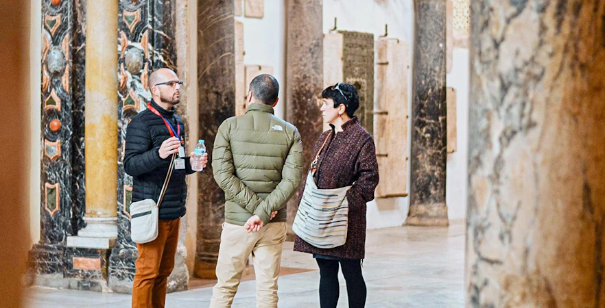 Tourists listening to a guide inside Cordoba Mosque-Cathedral.