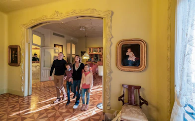 Visitors exploring an ornate room at La Pedrera-Casa Milà, Barcelona.