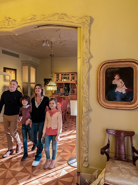 Visitors exploring an ornate room at La Pedrera-Casa Milà, Barcelona.