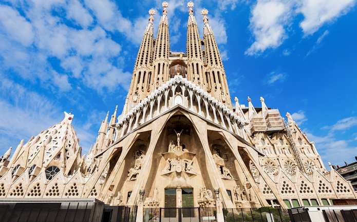 Sagrada Familia entrance with detailed facade and spires in Barcelona, Spain.