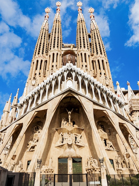 Sagrada Familia entrance with detailed facade and spires in Barcelona, Spain.