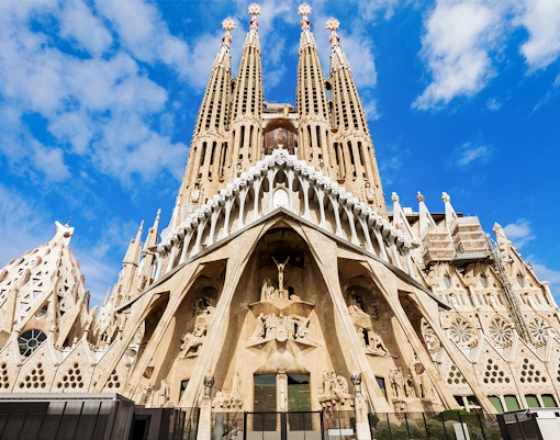 Sagrada Familia entrance with detailed facade and spires in Barcelona, Spain.