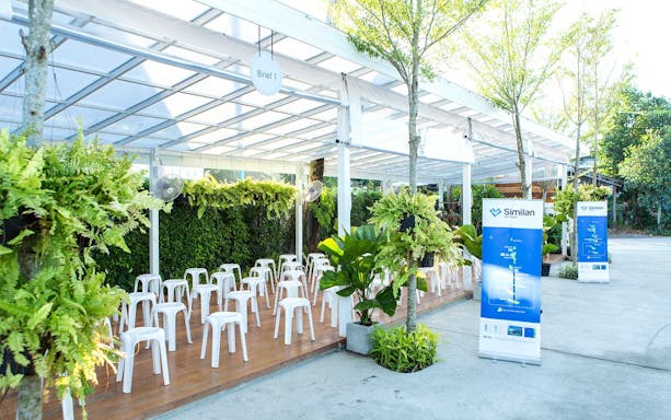 Outdoor briefing area for Similan Islands tour with chairs and informational banners.