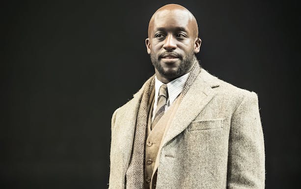 Performer in a suit on stage at Cabaret Westend show.