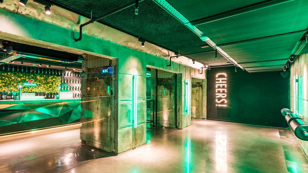 Heineken Experience tour entrance in Amsterdam with visitors exploring.