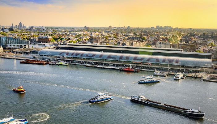 Amsterdam cityscape view from Lookout with boats on the IJ River.