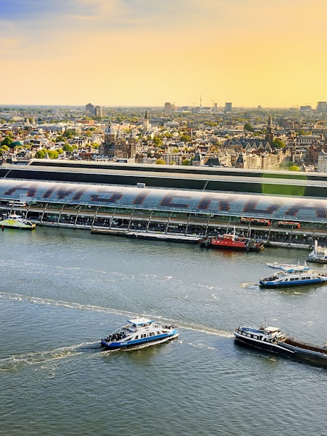 Amsterdam cityscape view from Lookout with boats on the IJ River.