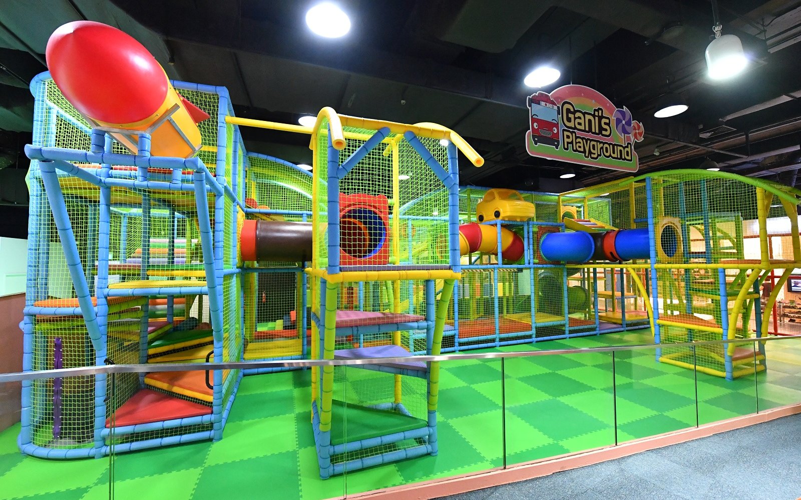 Indoor play structure at Ganis Playground, Tayo Station with colorful slides and climbing areas.
