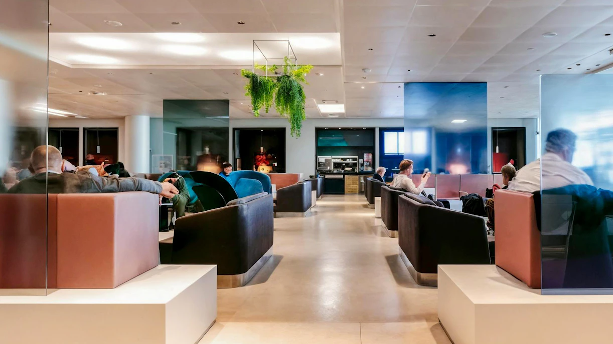 Aspire Lounge No.26 at Schiphol Airport with seating and greenery.