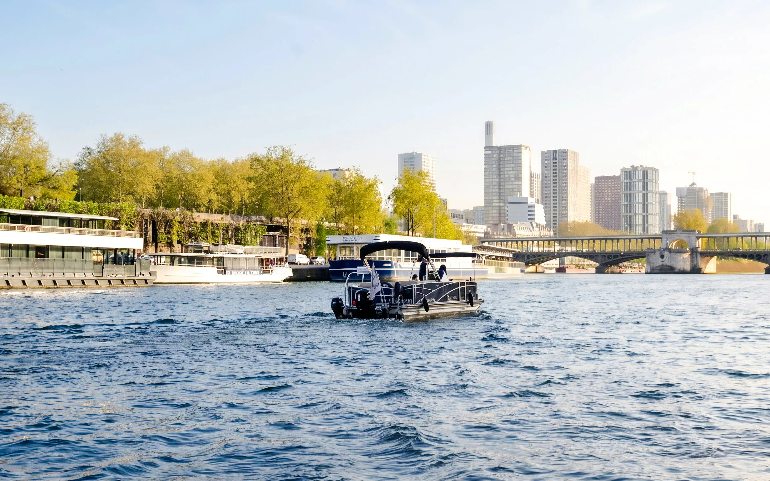 Private boat cruising on the Seine River towards the Eiffel Tower in Paris.