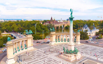 Heroe's Square with Millennium Monument in Budapest, Hungary, featuring statues and colonnade.