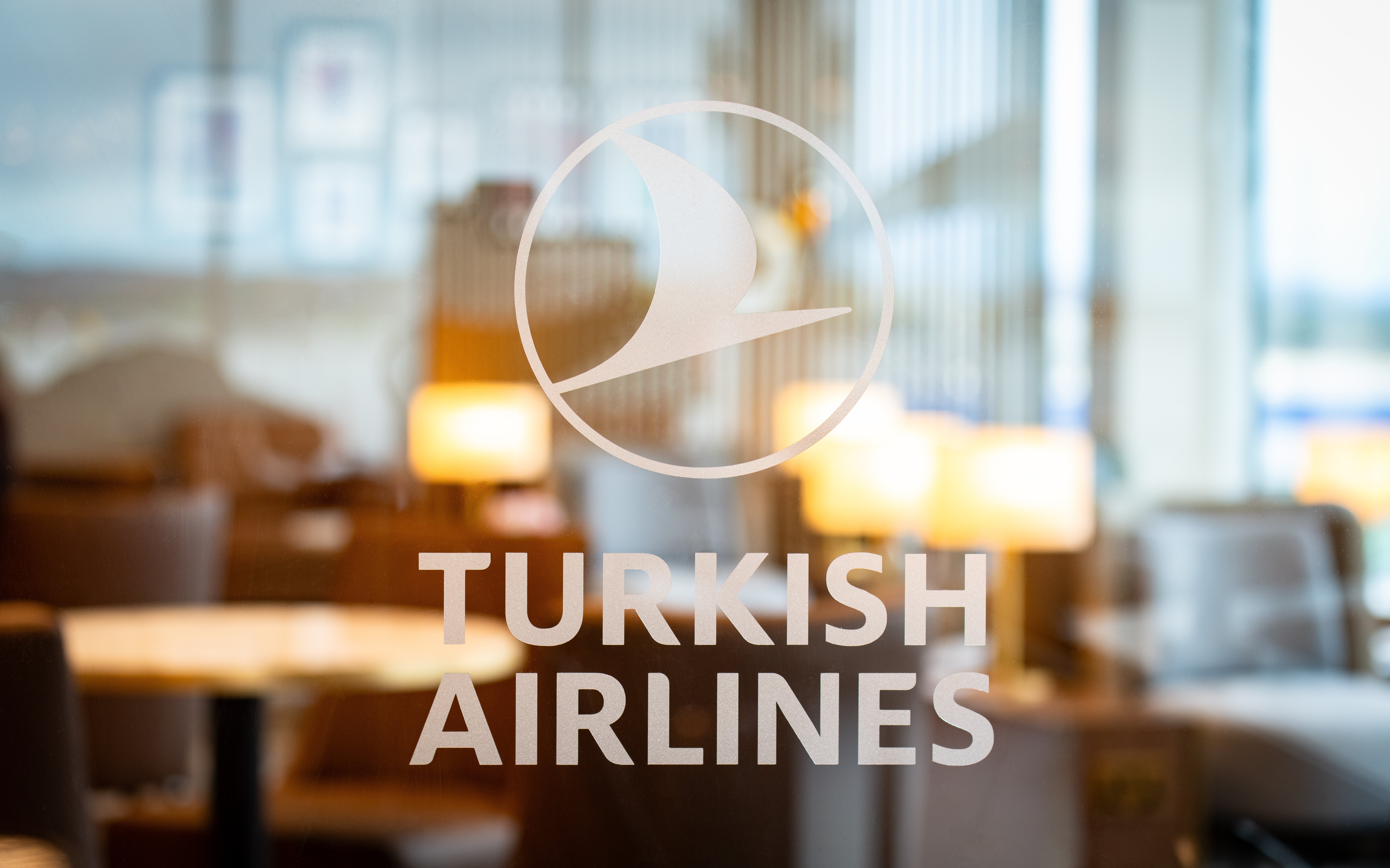 Turkish Airlines Lounge entrance at Edinburgh Airport with seating area in background.