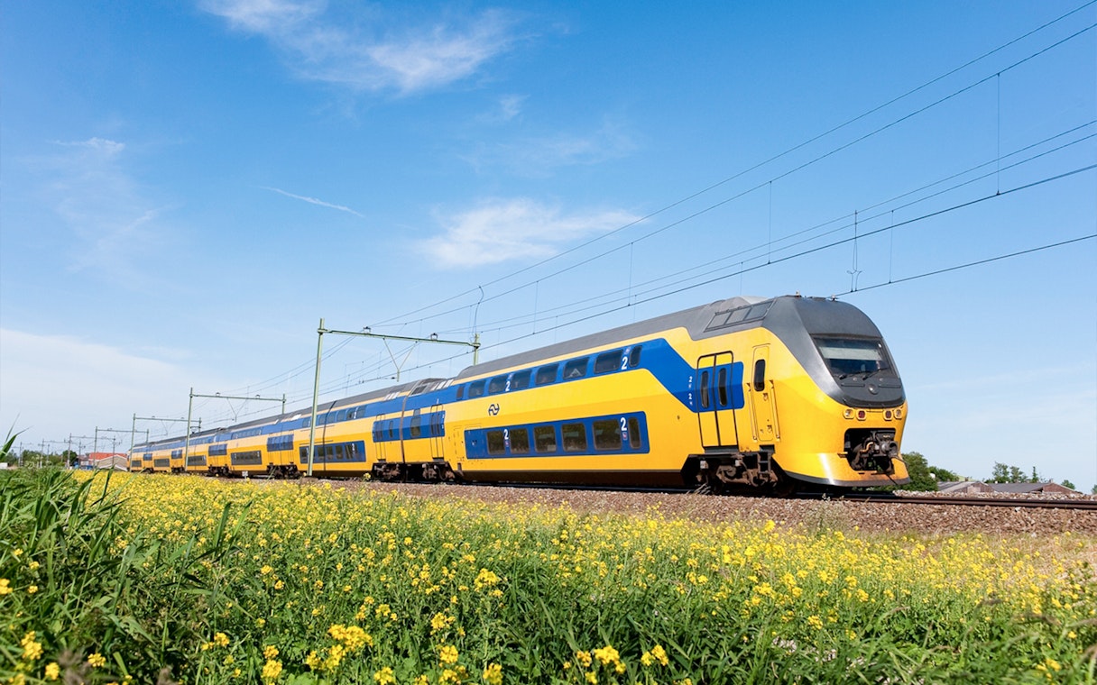 NS train traveling between Schiphol Airport and Amsterdam.