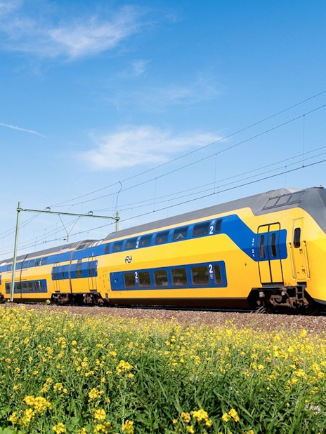NS train traveling between Schiphol Airport and Amsterdam.