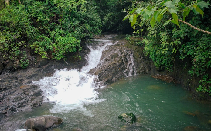 Waterfall surrounded by lush jungle on horseback riding tour from Manuel Antonio.