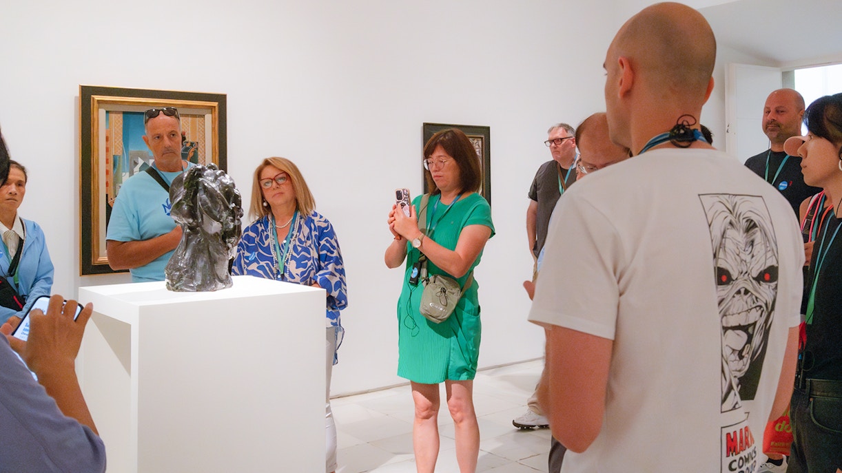 Tour guide explaining artwork to a group at the Prado & Reina Sofia Museum Guided Tour in Madrid, Spain