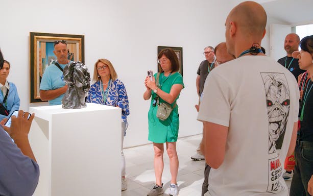 Visitors observing sculpture during Prado & Reina Sofia Museum guided tour.