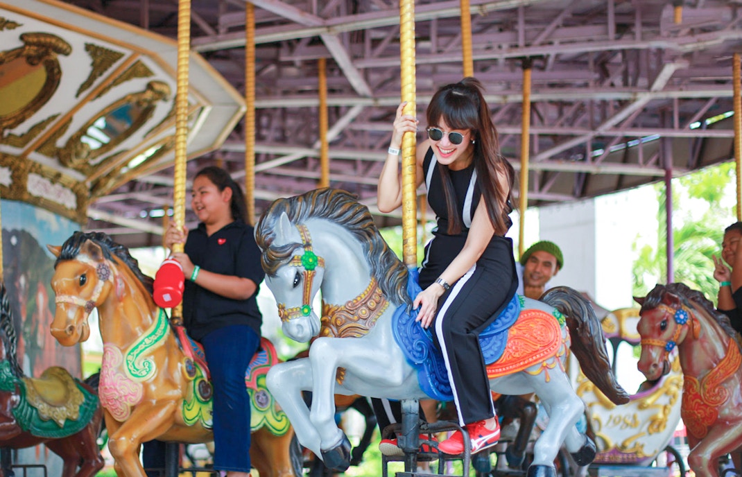 Children enjoying rides at Small World in Siam Amazing Park, Bangkok, Thailand.