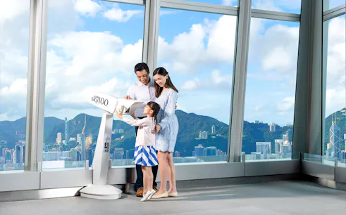 Family enjoying the view from Sky100 observation deck in Hong Kong.