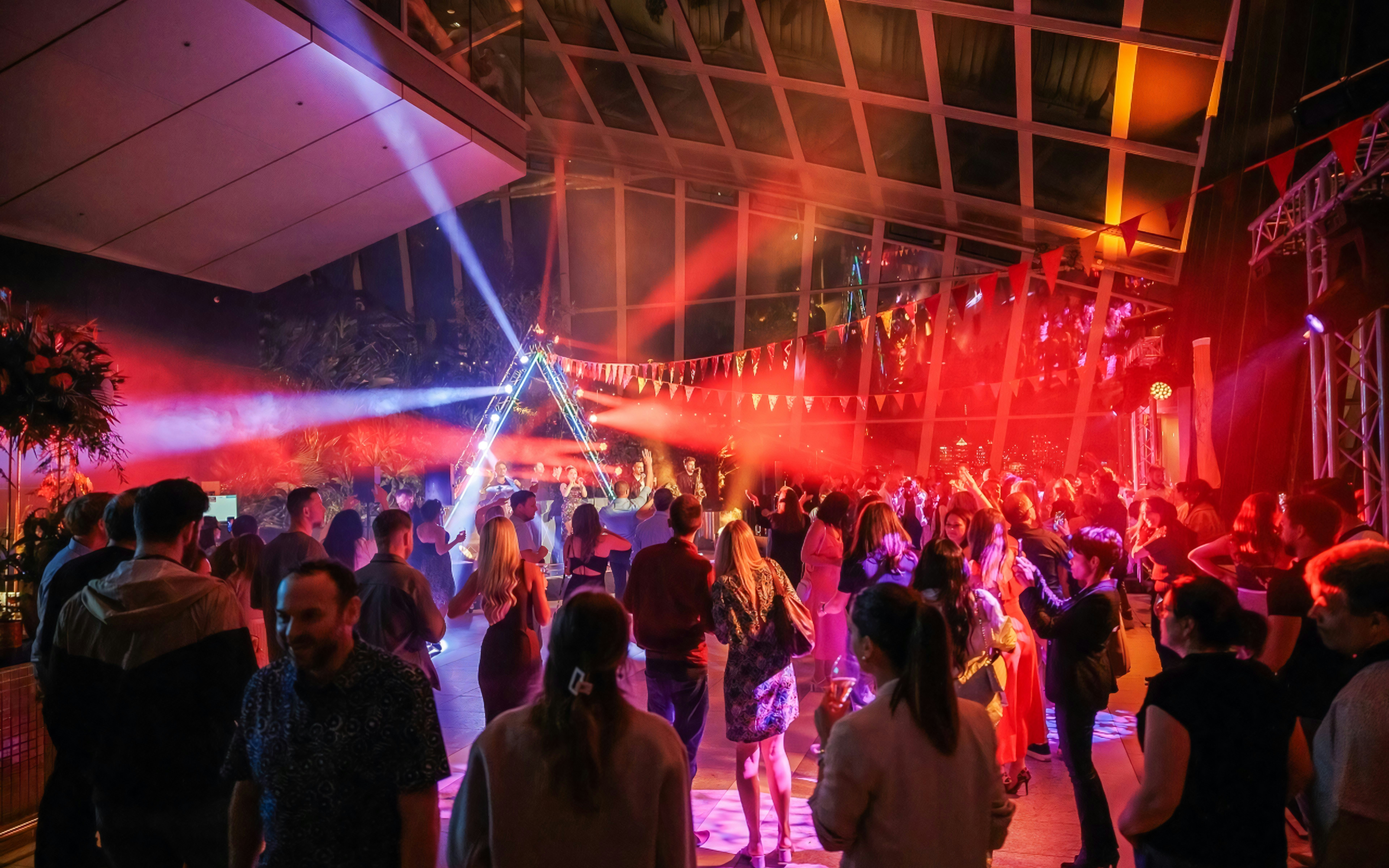 Crowd enjoying live music and lights at Sky Garden London event.